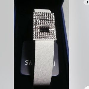 Swarovski white leather adjustable bracelet w/crystals encrusted silver buckle.